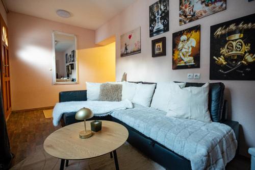 a living room with a couch and a table at Apartment Angel's Nest with Sauna and Fitness in Jesenice