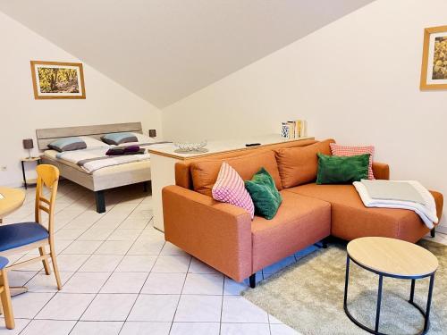 a living room with a couch and a bed at Ferienwohnungen Weingut Breit in Piesport