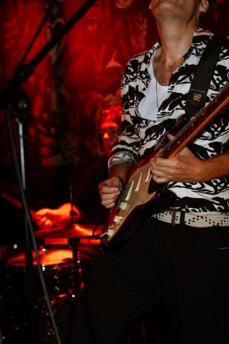 a man playing a guitar on a stage at St Christopher's Amsterdam - The Winston in Amsterdam