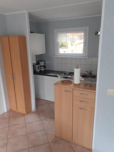 a kitchen with a counter and a window at Ferienbungalow Fleesensee in Malchow
