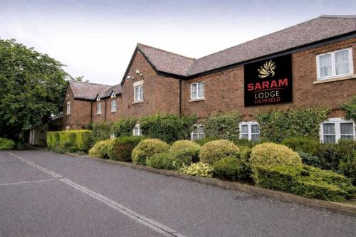 a building with a sign that reads saamn lodgelords at Saram Lodge Lichfield in Lichfield