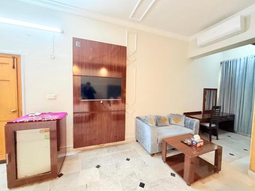 a living room with a couch and a table at Royal Continental in Islamabad