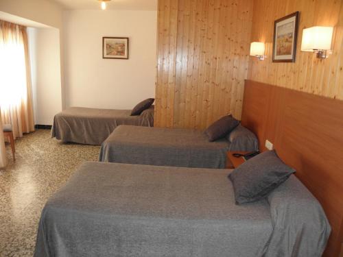 Ένα ή περισσότερα κρεβάτια σε δωμάτιο στο Hotel Jardín