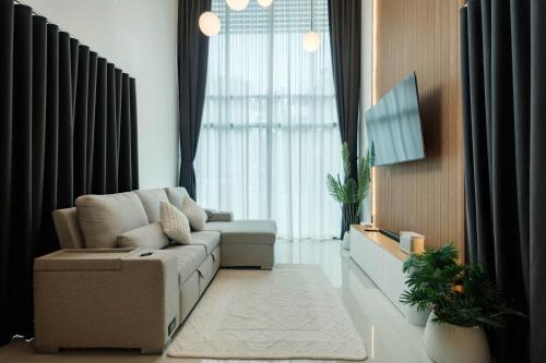 a living room with a couch and a large window at P Square Villa in Ban Krabi Yai
