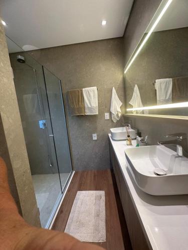 a bathroom with a sink and a shower at Casa Céu do Siriú in Garopaba
