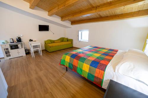 a bedroom with a bed and a couch in a room at B&B Anele in Morano Calabro