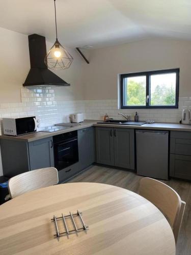 a kitchen with a table and chairs in it at Les rÉdÉlÉs in Saulces-Monclin