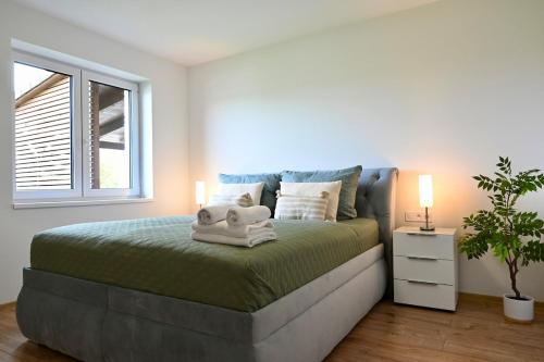 a bedroom with a bed with a stuffed animal on it at Pool & Relax Mukařov in Srbín