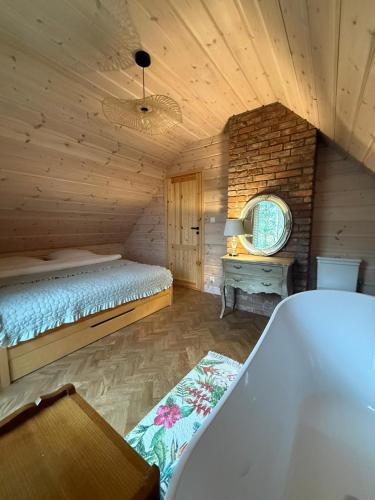 Postel nebo postele na pokoji v ubytování Bursztynowy domek