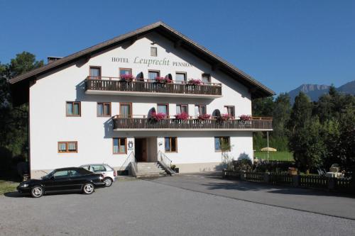 a building with a car parked in front of it at Pension Leuprecht in Reutte
