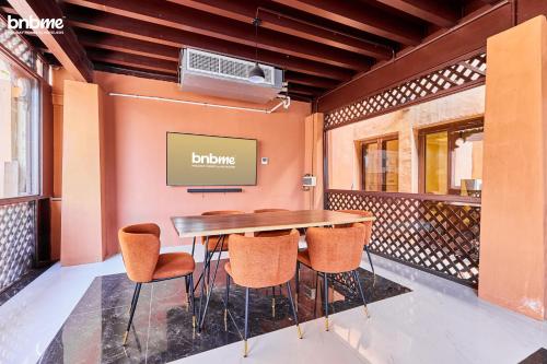 a dining room with a table and chairs at bnbmehomes - Al Badia Hillside Village Condo 3 in Dubai