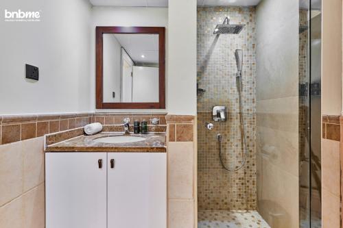 a bathroom with a sink and a shower at bnbmehomes - Al Badia Hillside Village Condo 3 in Dubai