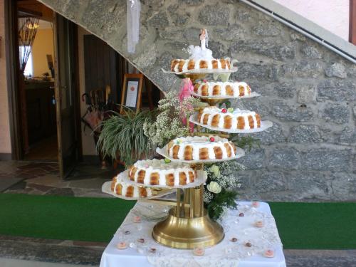 a cake server with several tiers of cookies on it at Hotel Ristorante Miravalle in Teglio