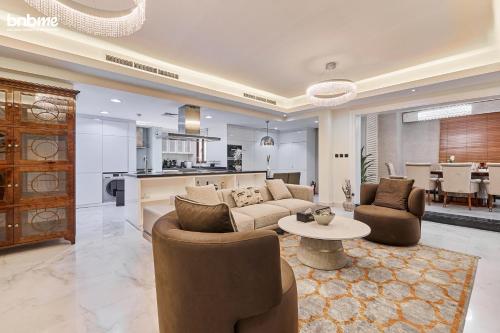 a living room with a couch and chairs and a table at bnbmehomes - Al Badia Hillside Village Condo 3 in Dubai