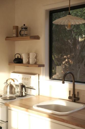 a kitchen counter with a sink and a window at Gills in Murdunna