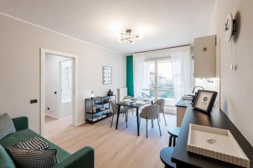 a living room with a green couch and a table at V-Home Holiday Moro 60 in Grassobbio