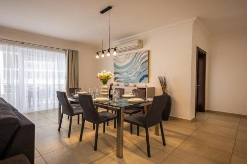 a dining room with a table and chairs at Luxury Apartments with Pool and Terrace, Top Location in Sliema