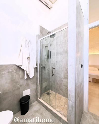 a shower with a glass door in a bathroom at Amati home in Floridia