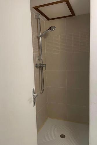 a shower with a shower head in a bathroom at Chambre avec SDB privé in Montpellier