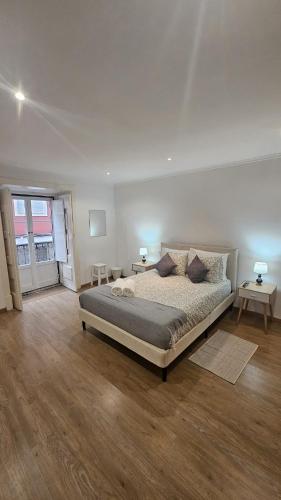a bedroom with a large bed and two tables at Lisbon Prime Residence Rato - Casa de Hóspedes in Lisbon