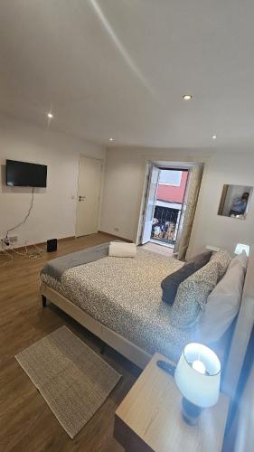 a bedroom with a large bed and a large window at Lisbon Prime Residence Rato - Casa de Hóspedes in Lisbon