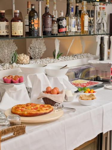 a buffet with pizza and other food on a table at Dimora Intini in Noci