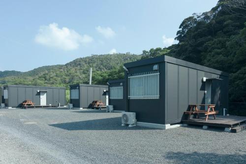a row of portable toilets in a parking lot at A-Mami 315 in Amami
