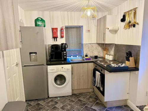 eine Küche mit Waschmaschine und Waschmaschine in der Unterkunft Luxury Studio Apartment Birmingham in Birmingham