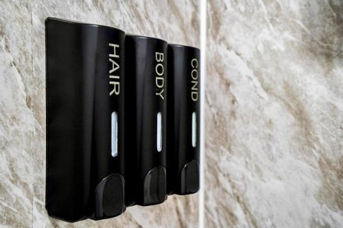 eine Gruppe schwarzer Bücher, die an einer Wand hängen in der Unterkunft Luxury Studio Apartment Birmingham in Birmingham