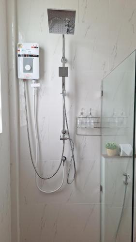 a shower in a white bathroom with a shower at Mama Home Misty Lakeside in Pong