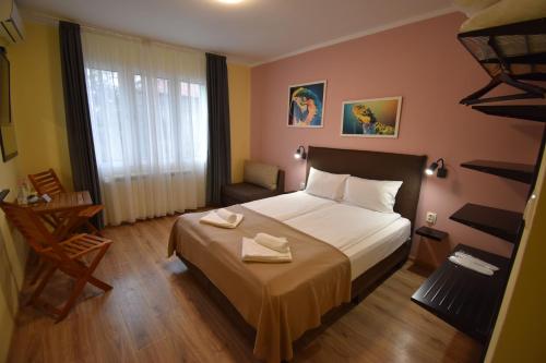 a bedroom with a bed with two towels on it at Simada Green Guesthouse in Varshets