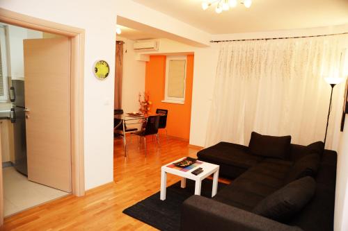 a living room with a couch and a table at Exclusive Skopje Apartments in Skopje