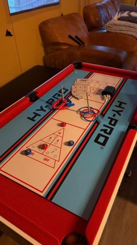 a ping pong table with a game on it at Jungle Book Safari Tent in Tenby