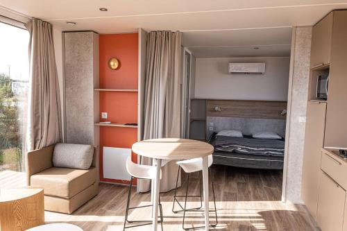 a small room with a small table and a bed at Camping Les Bois Flottés in Salin-de-Giraud