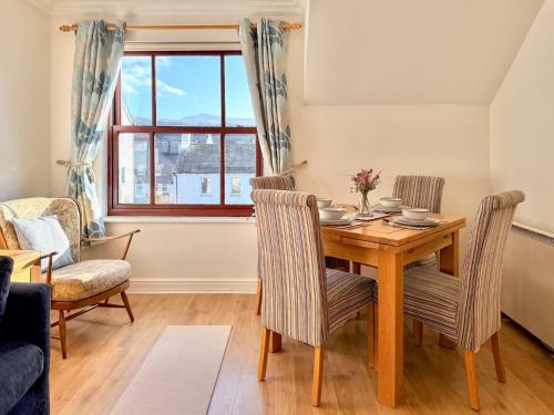 een eetkamer met een houten tafel en stoelen bij Hindscarth in Keswick