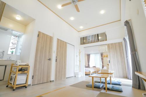 a living room with a door and a table at Villa Sunbeams ヴィラ・サンビームス in Kin