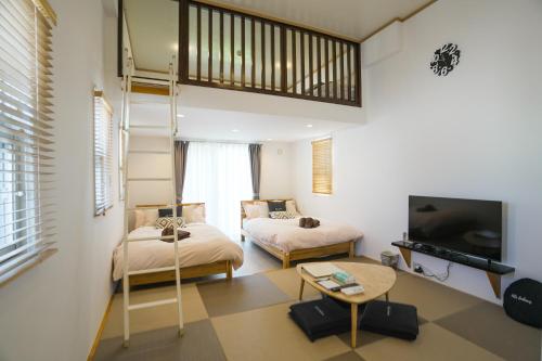 Postel nebo postele na pokoji v ubytování Villa Sunbeams ヴィラ・サンビームス