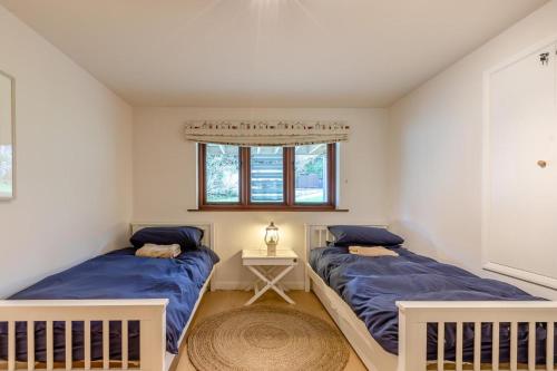 a bedroom with two beds and a window at 3 Bed in Croyde oc-t30753 in Croyde