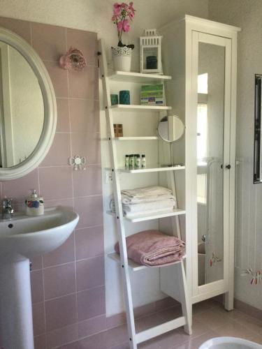 a bathroom with a ladder shelf next to a sink at B&B Le Tre Casette in Maratea
