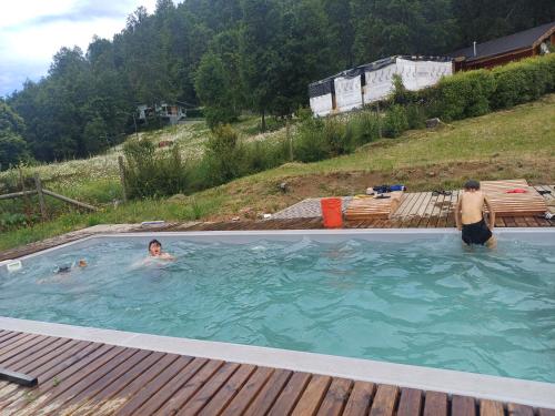 two people swimming in a swimming pool at Carrusel in Trape