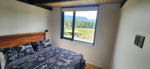 a bedroom with a bed and a large window at Carrusel in Trape