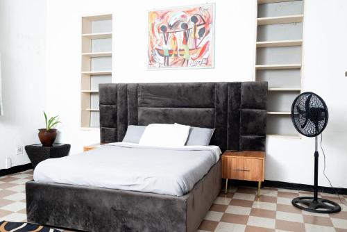 un letto con testiera nera in una stanza di Henderson street lodge a Blantyre