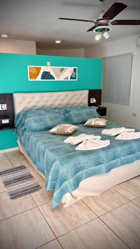 a large bed with a blue comforter in a room at ARROYO SUITE HOUSE in Mina Clavero