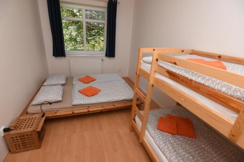 a room with two bunk beds and a window at Apartment Spindleruv Mlyn Labska in Špindlerův Mlýn