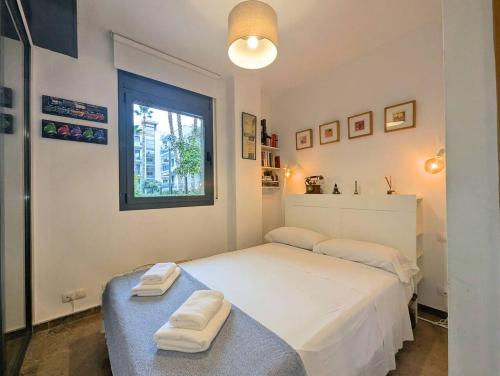 a bedroom with a bed with two towels on it at Relax en Lloret con Gym y Piscina by Host&Joy in Lloret de Mar