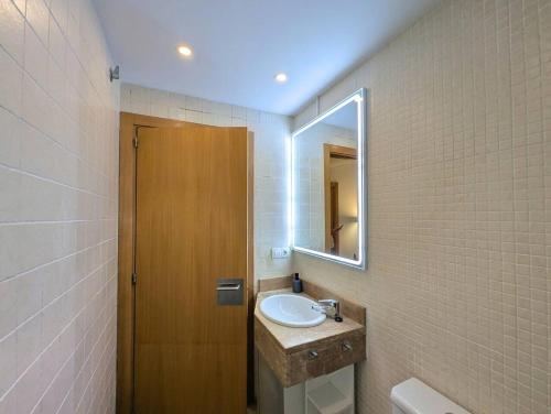 a bathroom with a sink and a mirror at Relax en Lloret con Gym y Piscina by Host&Joy in Lloret de Mar