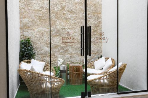 a group of chairs in front of a window at Liora Boutique in Riyadh