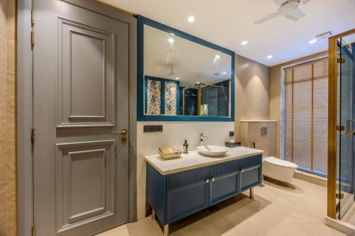 a bathroom with a blue sink and a toilet at Valley View 5-BHK Villa With Private Pool, Sit-out Areas, TT Table, Pool Table , Bar & Scenic Views in Mapusa