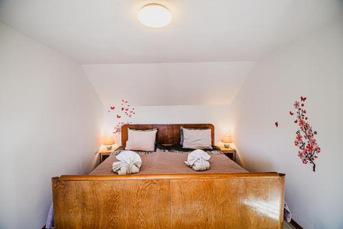 a bedroom with a wooden bed with two towels at Traditional Slovenian House Pr'Belej in Zgornje Gorje
