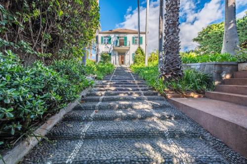 a cobblestone street in front of a house at Quintinha de São Martinho - Villa & Lux in Funchal